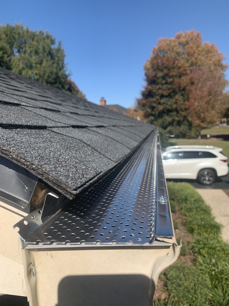 Roof of a house showing gutter and gutter guard protection against leaves